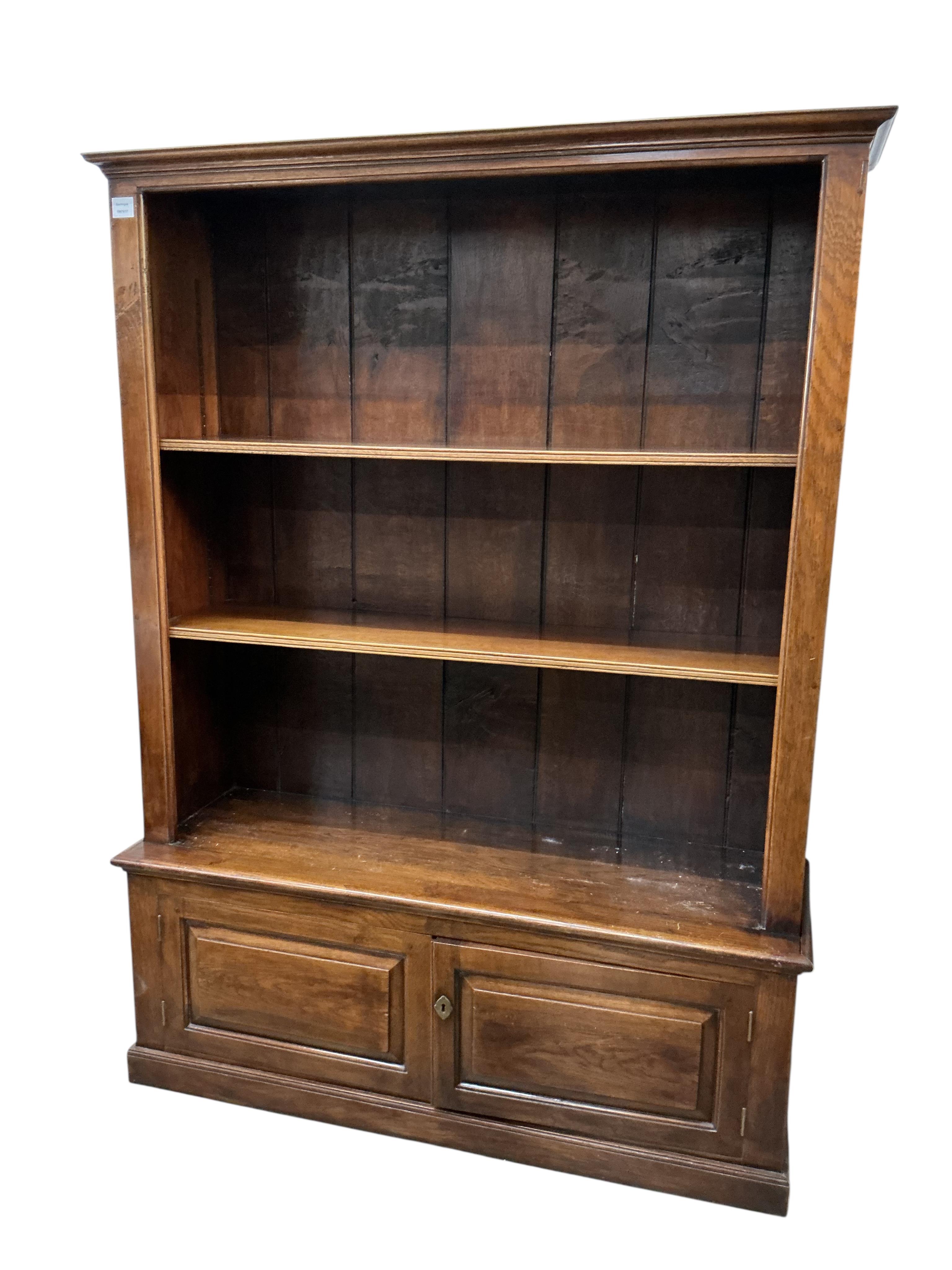 An reproduction oak open bookcase / cupboard, width 128cm, depth 41cm, height 172cm